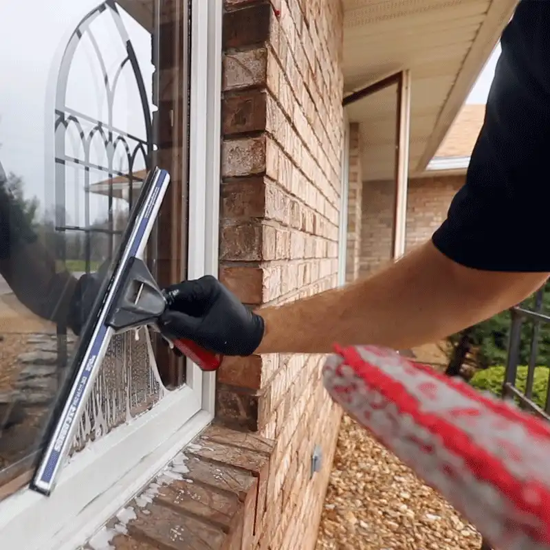 window cleaning professional in black gloves