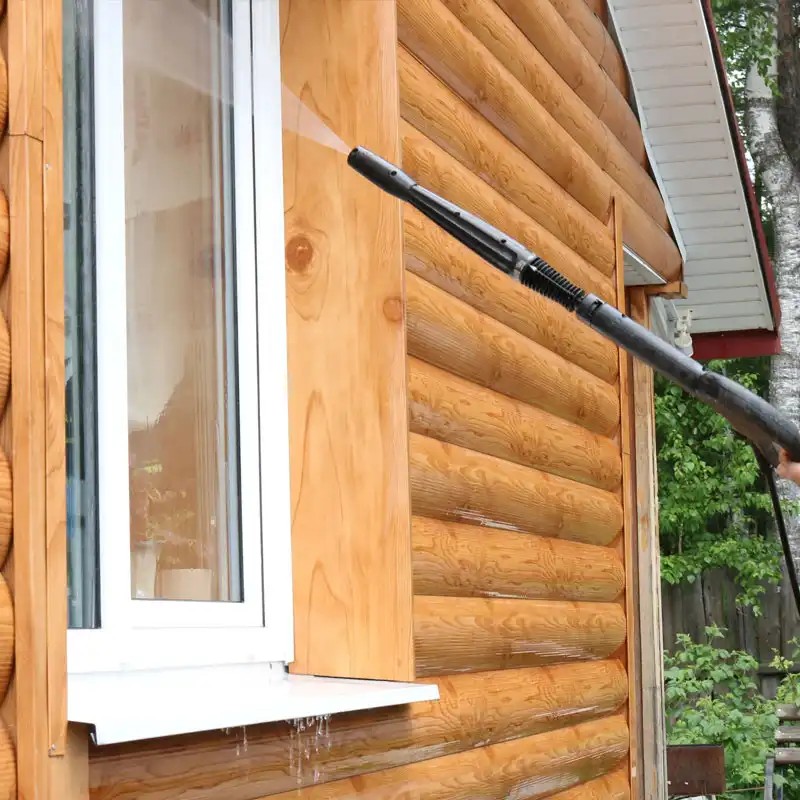 window cleaning professional cleaning window on brown cabin